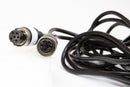 A 6-6 pin video cable with black connectors on both ends, coiled and laid out on a white background.