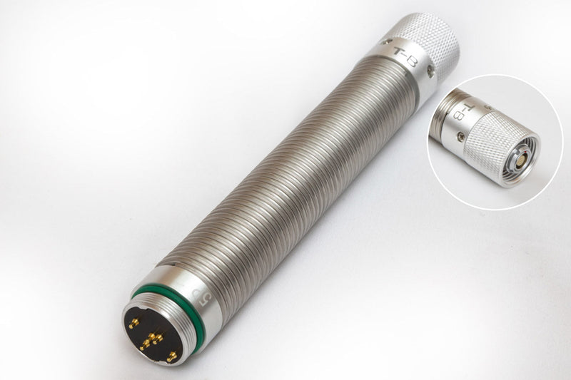 A stainless steel spring with 5 pin and 6 pin connectors on opposite ends.